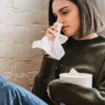 Crying young lady wiping tears with tissue