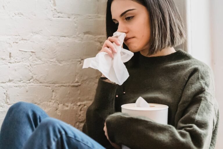 Crying young lady wiping tears with tissue